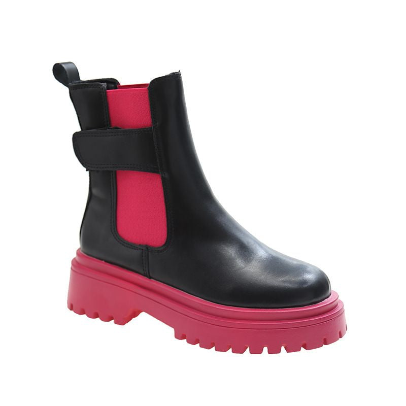 A black Chelsea-style ankle boot with a chunky bright pink sole and a matching pink side panel, shown on a plain white background.