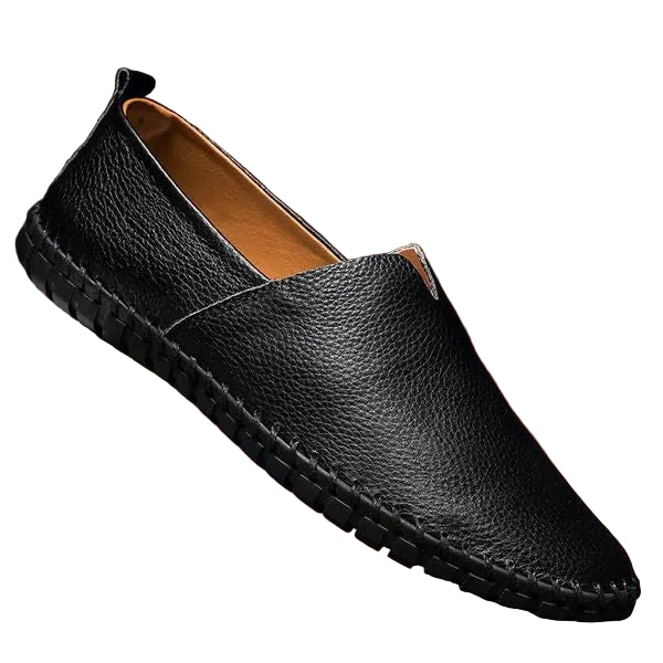 Black leather loafer shoe on a brown background