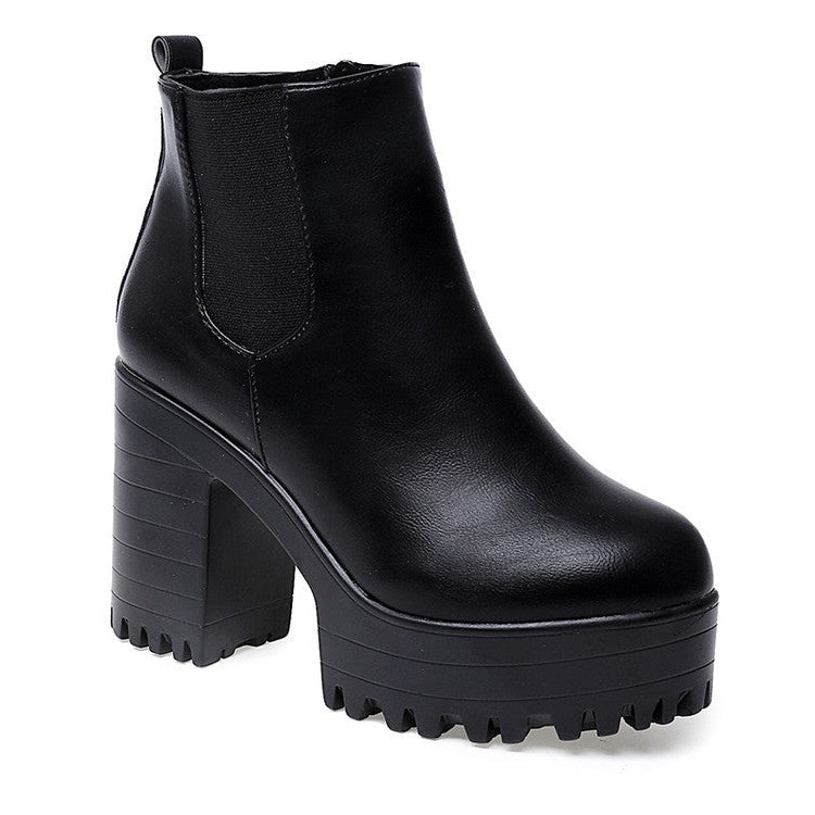 Black platform ankle boot on a white background