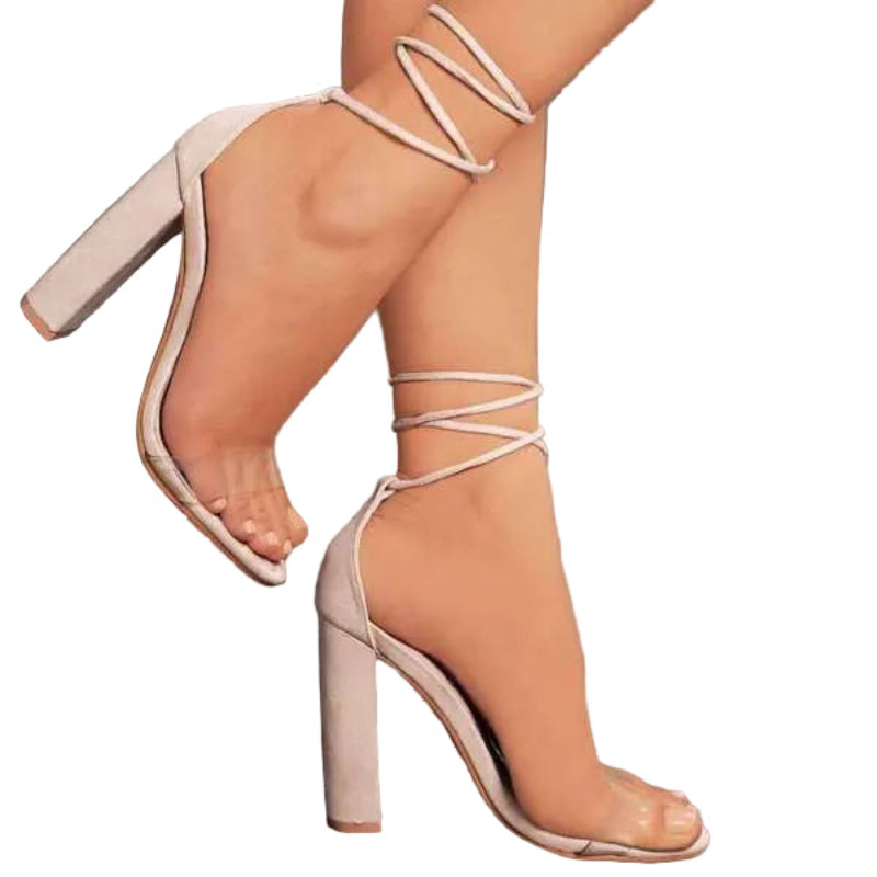 Beige high-heeled sandals with strappy design on a neutral background